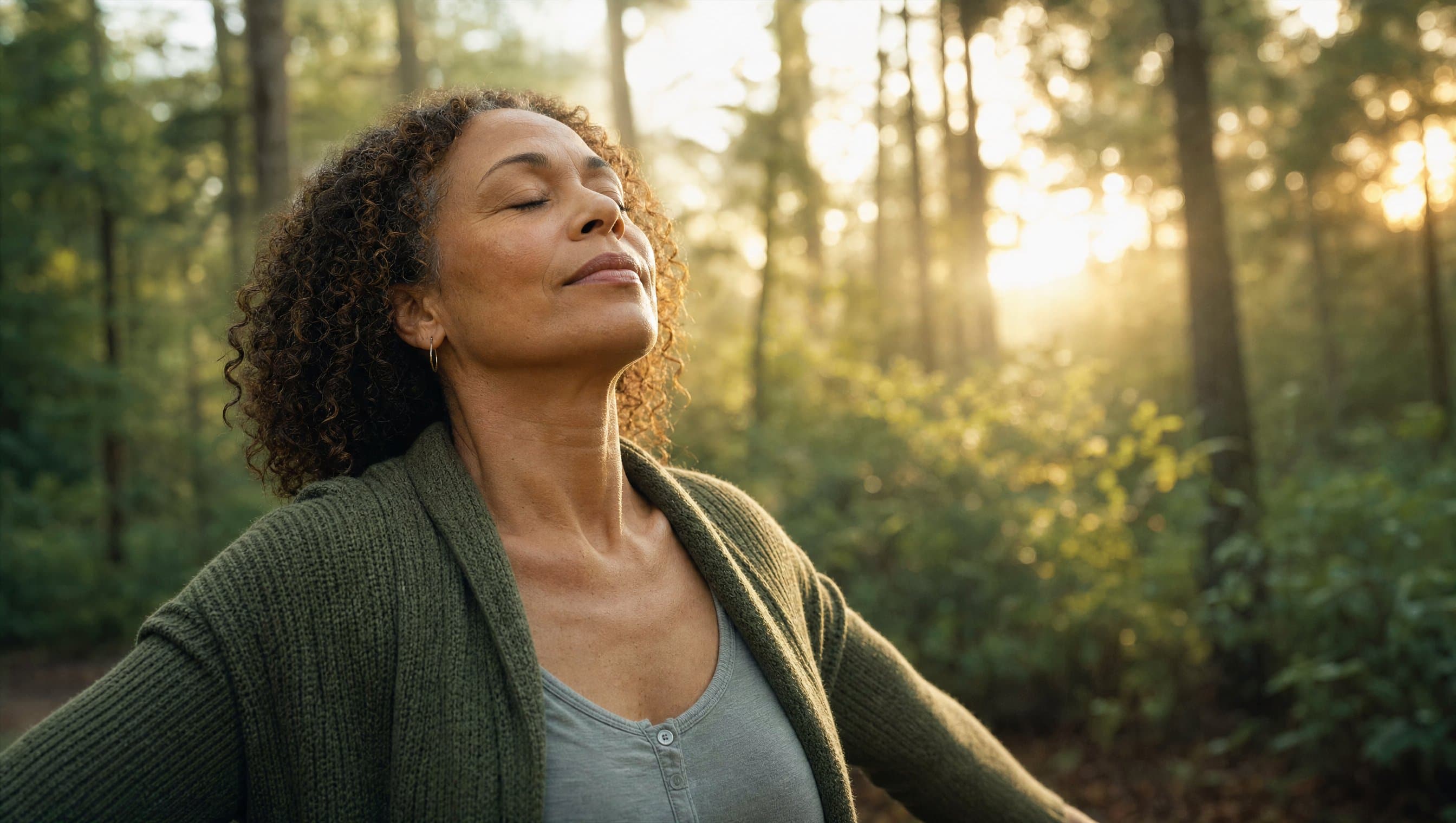 Person breathing deeply outdoors in warm morning light
